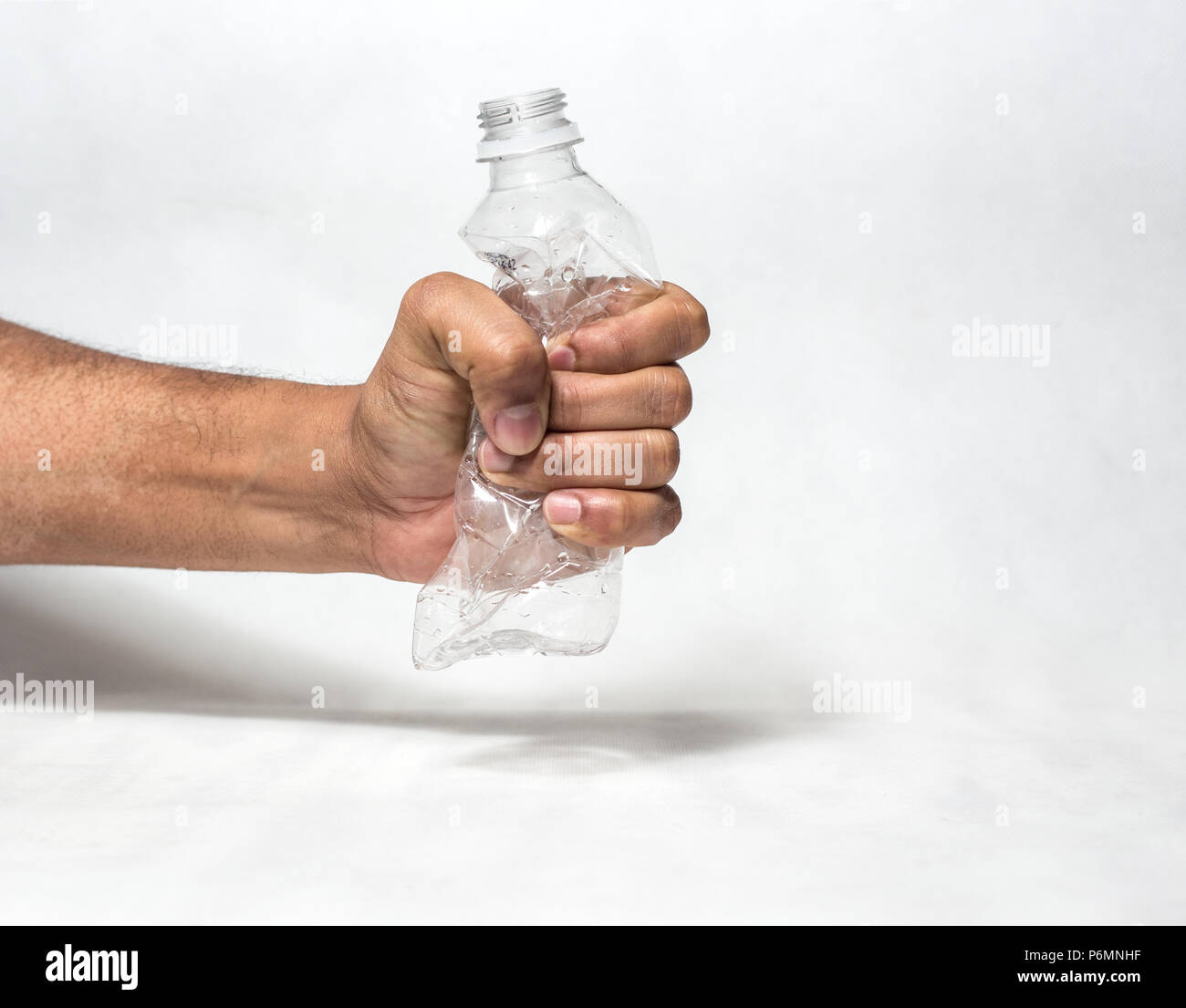 hand squashing empty plastic water bottle resembling ban of single use  plastic recycle Stock Photo - Alamy