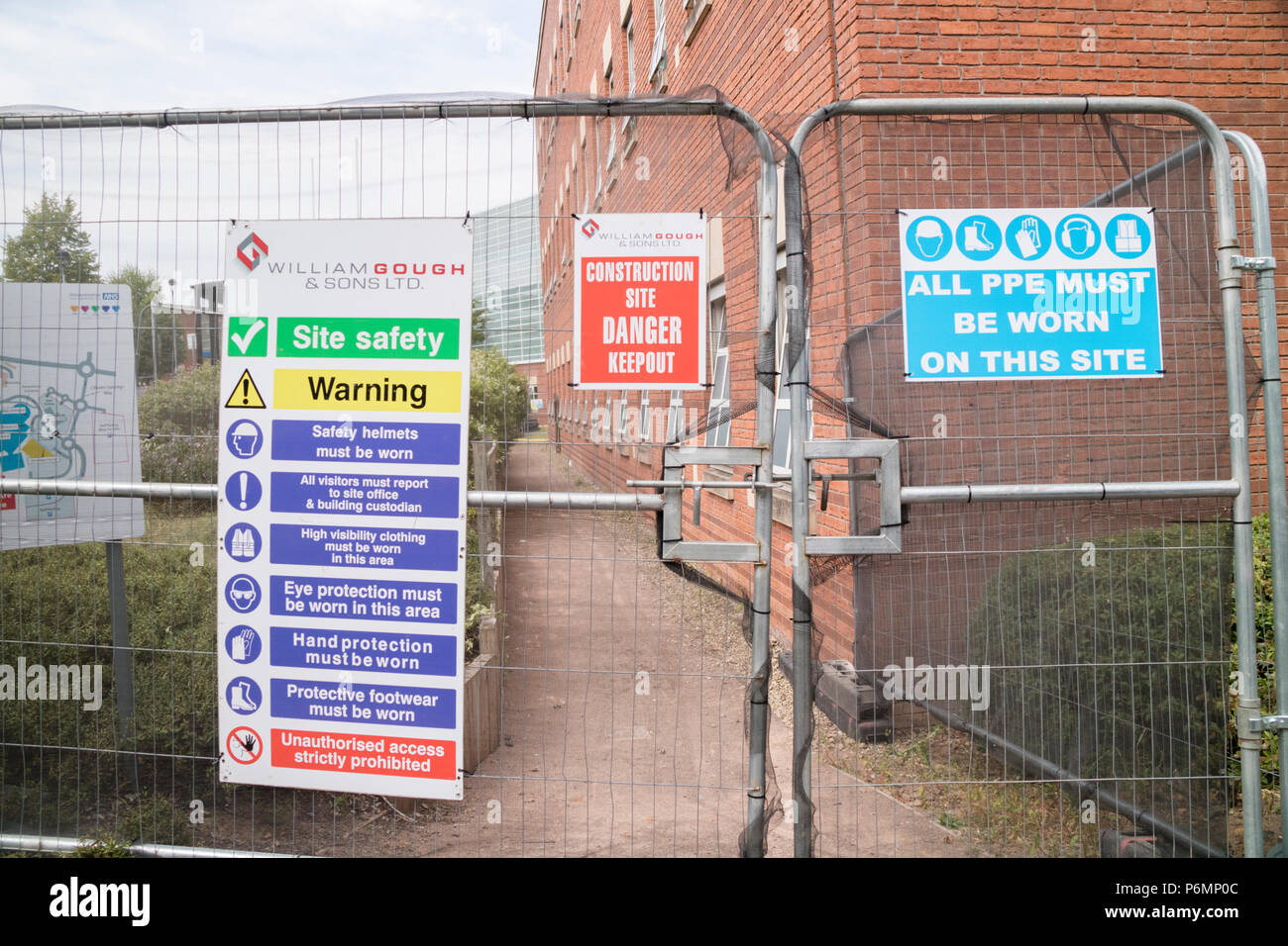 Health and safety signage and security fencing on a construction site, England, UK Stock Photo