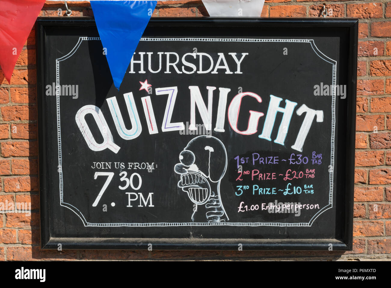 Notice giving information about a weekly Thursday quiz night on the exterior of a pub in Guildford, Surrey, UK Stock Photo