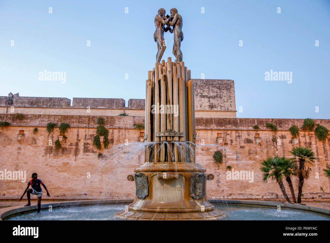 Boy wading in a Maglie fountain, italy. Stock Photo