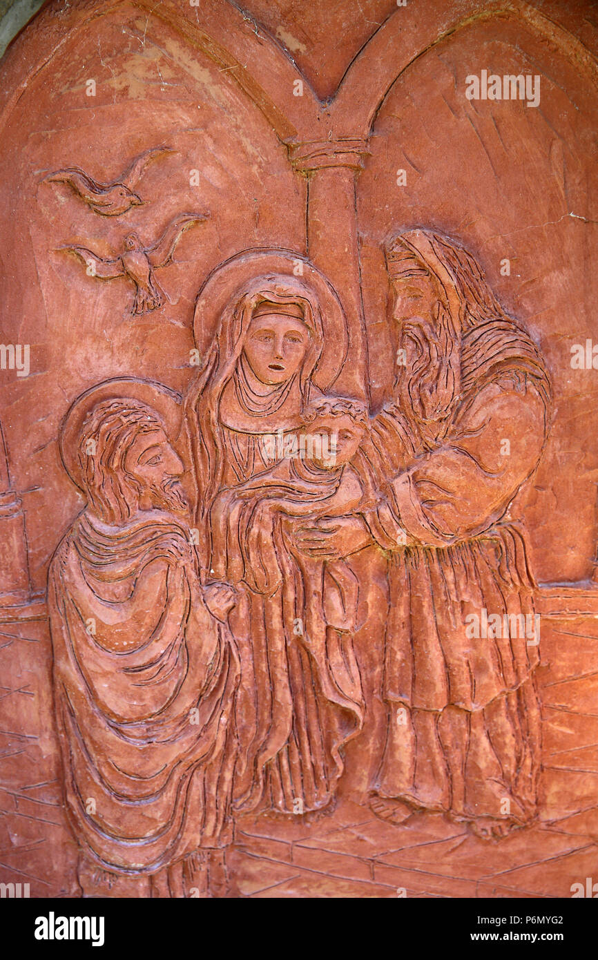 Relief depicting the Holy Family in the synagogue in a catholic sanctuary, Italy. Stock Photo