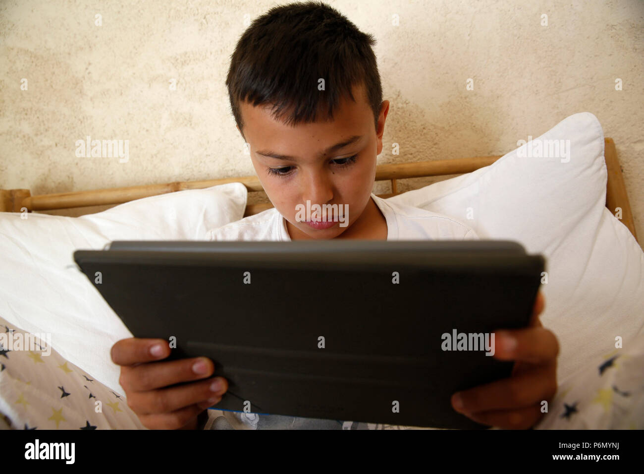 11-year-old boy using a digital tablet in Salento, Italy. Stock Photo