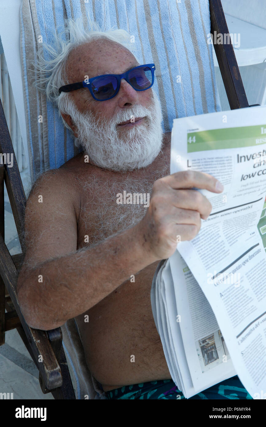 Elderly Italian reading a newspaper in Salento, Italy. Stock Photo