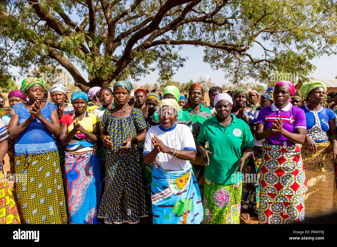 Members of a women's microfinance cooperative welcoming a visitor in Northern Togo. Stock Photo