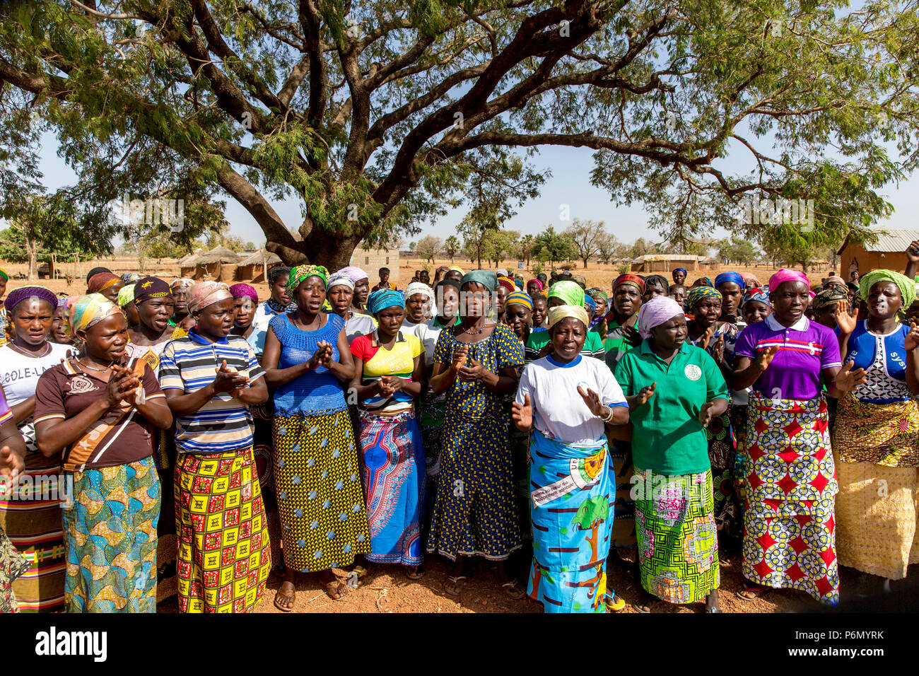 Members of a women's microfinance cooperative welcoming a visitor in Northern Togo. Stock Photo