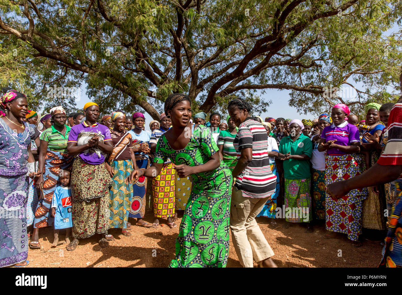 Members of a women's microfinance cooperative welcoming a visitor with dances in Northern Togo. Stock Photo