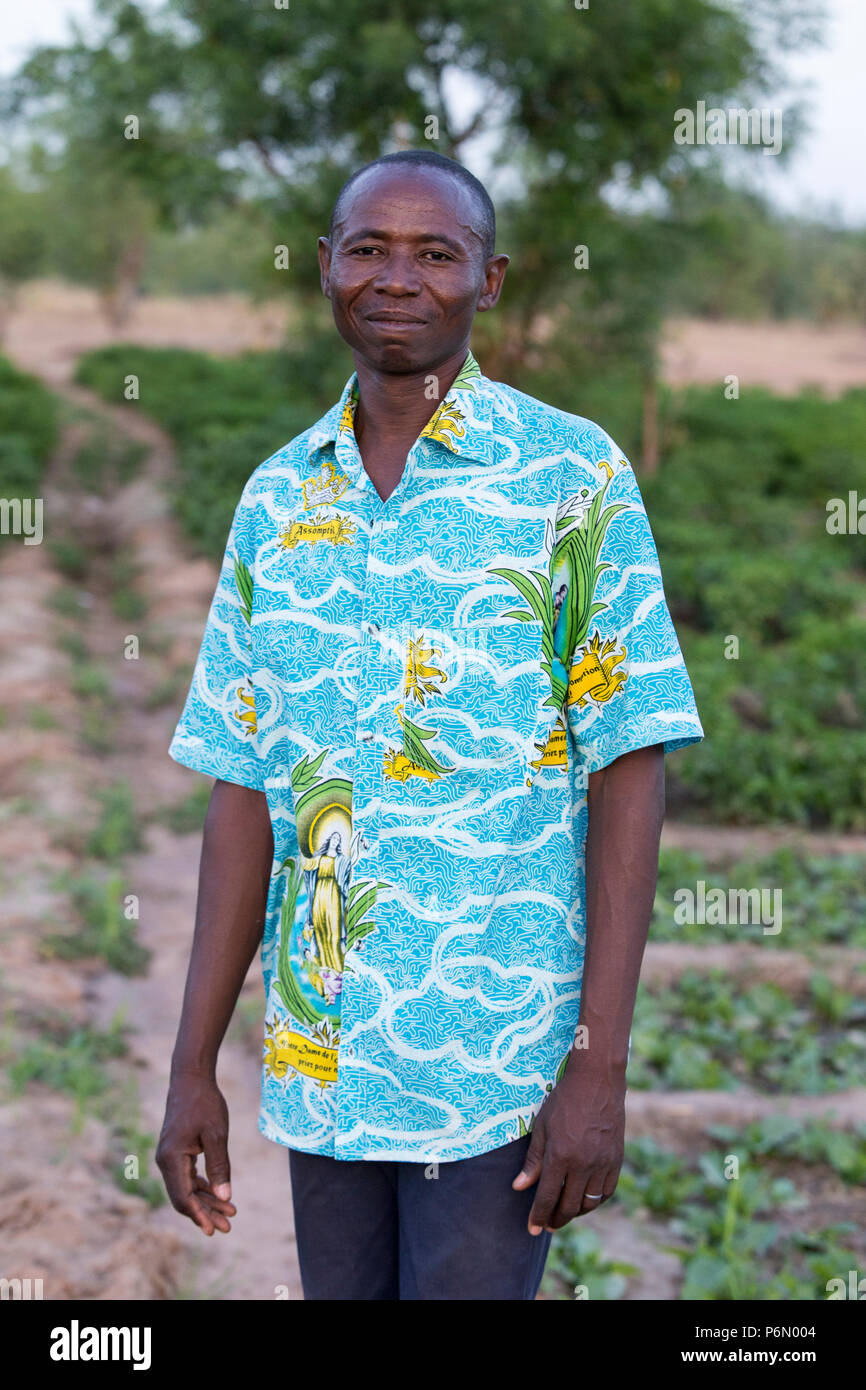 Staff worker of COOPEC-SIFA microfinance cooperative in a field in Karsome, Togo. Stock Photo