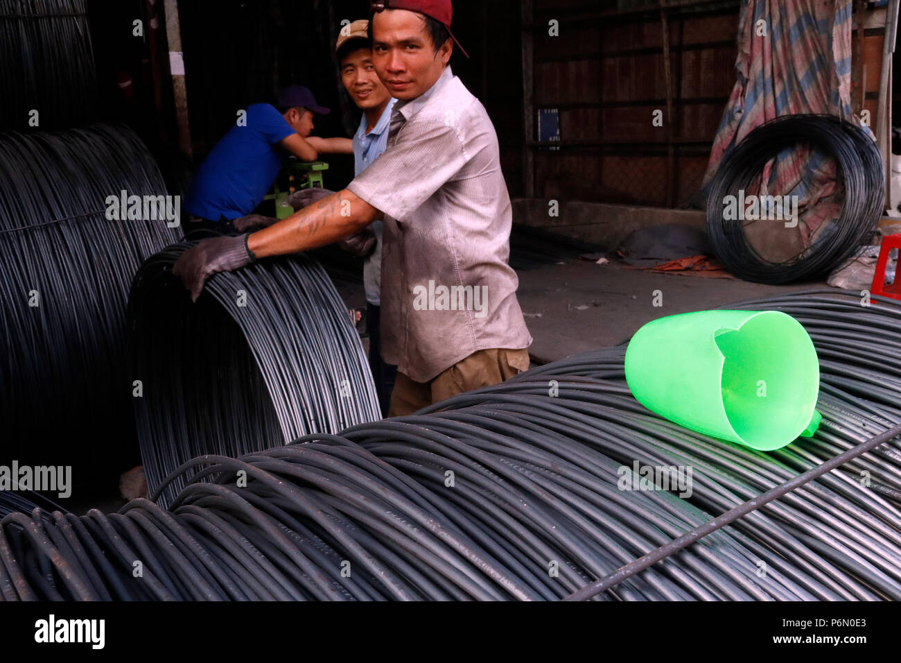 Steel rebar for concrete reinforcing construction building industry.  Construction workers.  Cai Be. Vietnam. Stock Photo