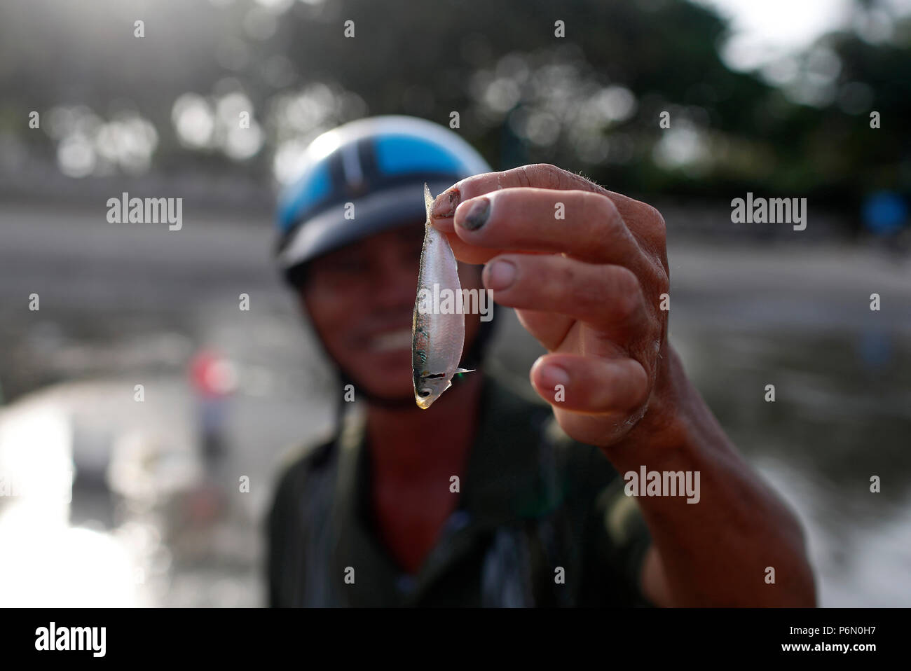 Fisherman with small fish.  Vung Tau. Vietnam. Stock Photo
