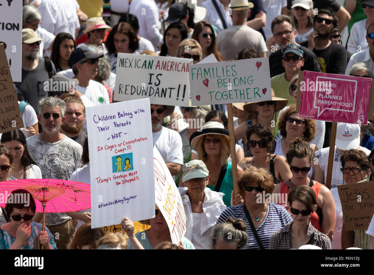 A crowd of protesters hold signs at the Families Belong Together rally in Asheville, NC, USA Stock Photo