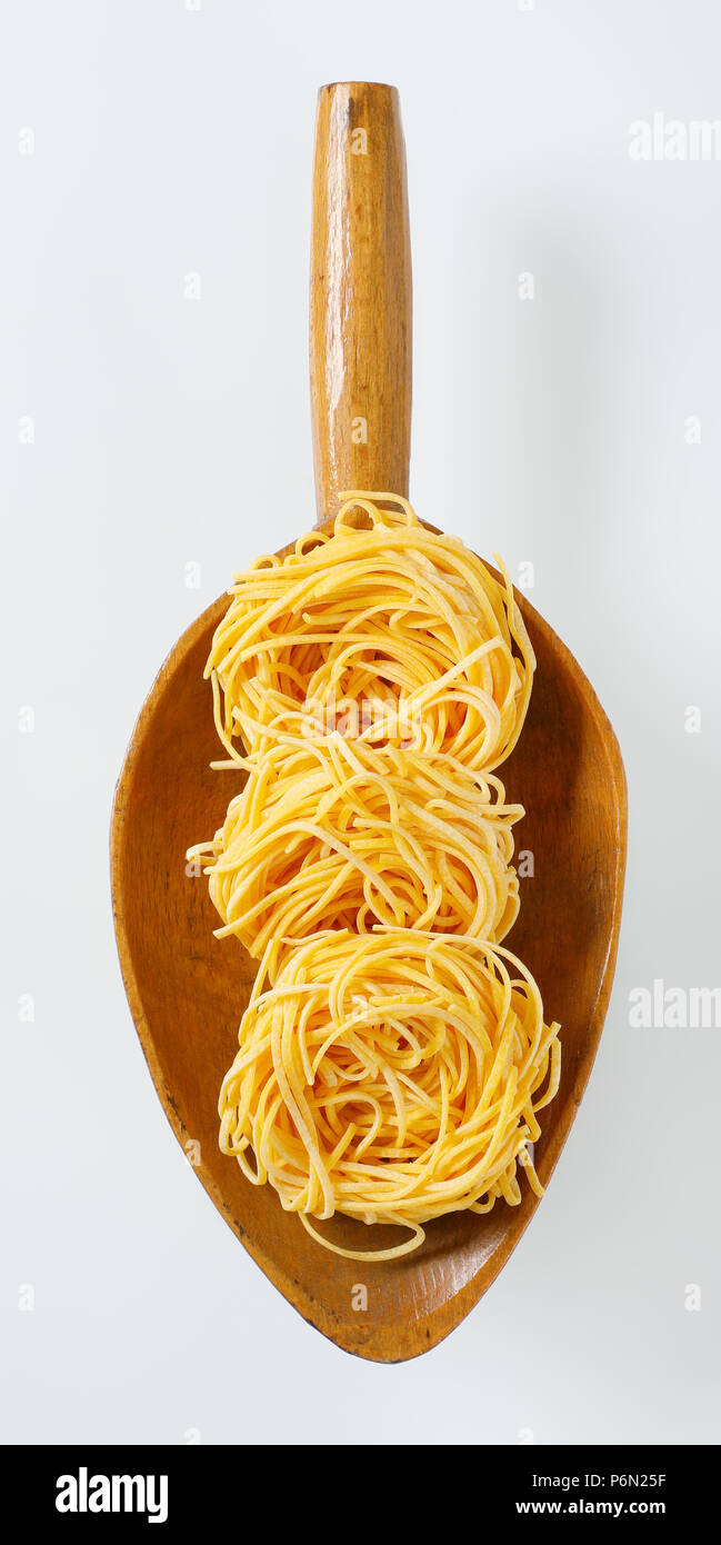 bundles of spaghetti pasta in wooden scoop Stock Photo