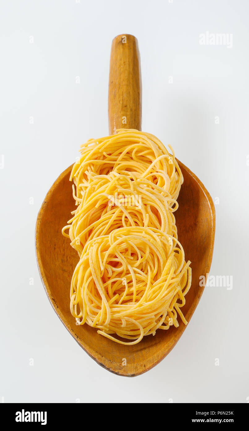 bundles of spaghetti pasta in wooden scoop Stock Photo