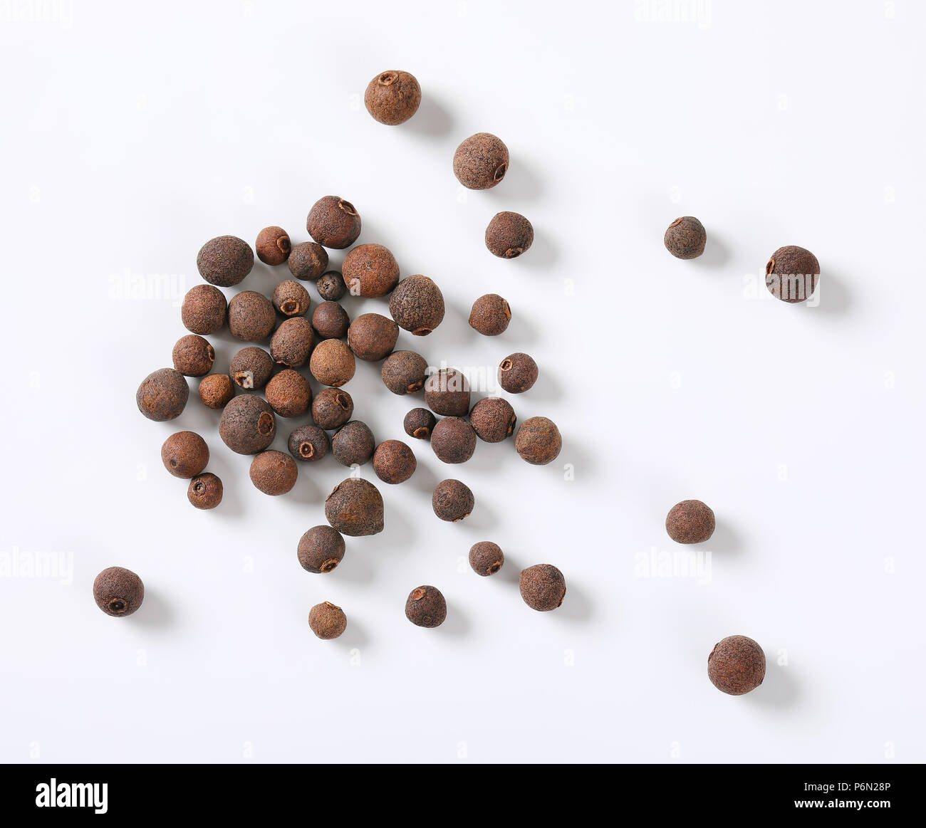 handful of whole allspice berries on white background Stock Photo