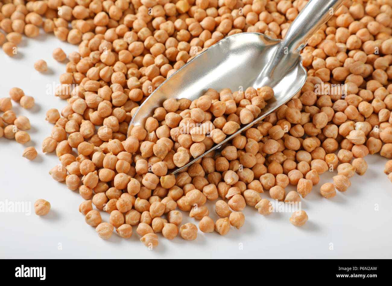 grains of raw chickpeas and silver scoop Stock Photo