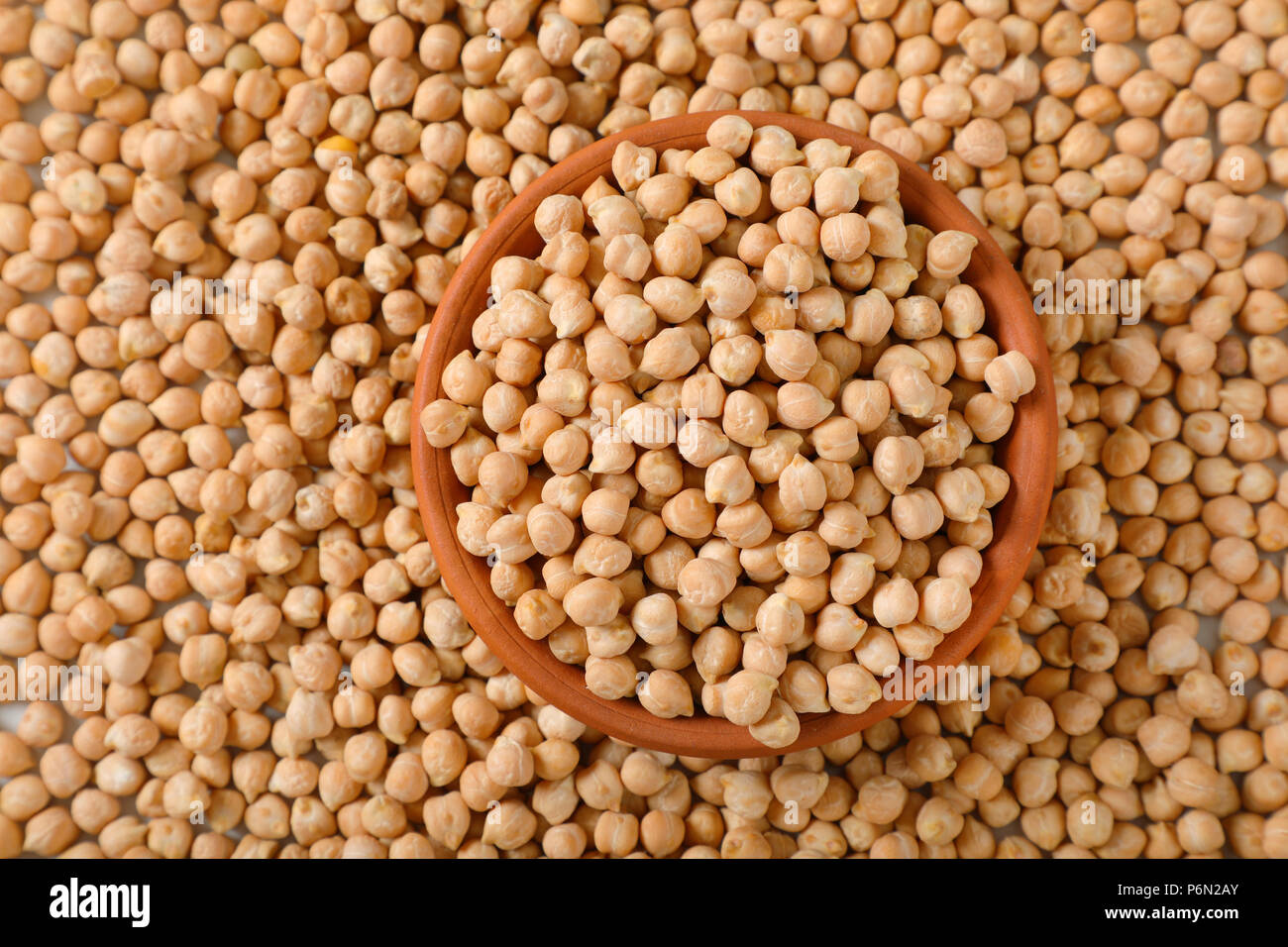 bowl of raw chickpeas on chickpeas background Stock Photo