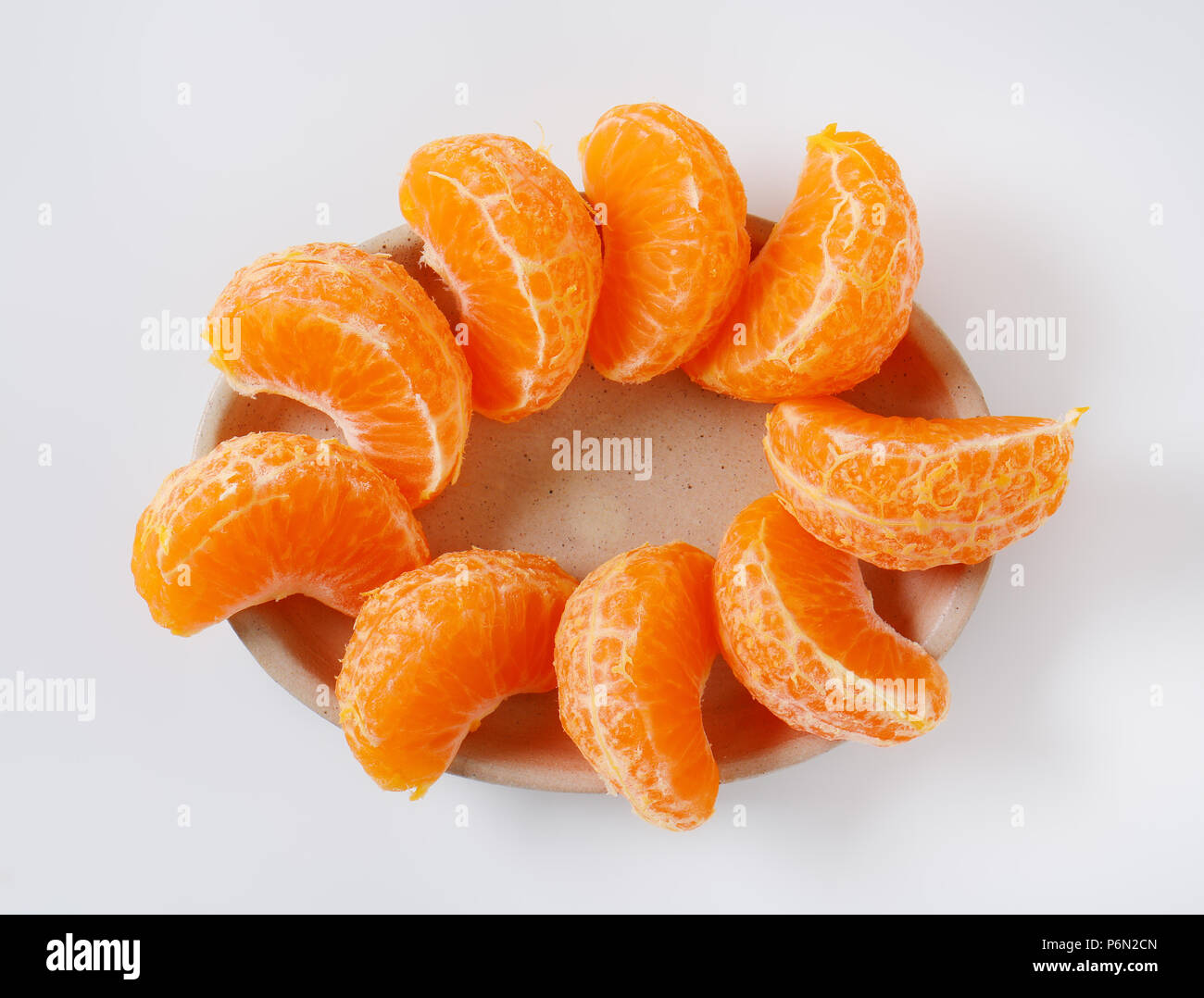 plate of fresh tangerine slices on white background Stock Photo