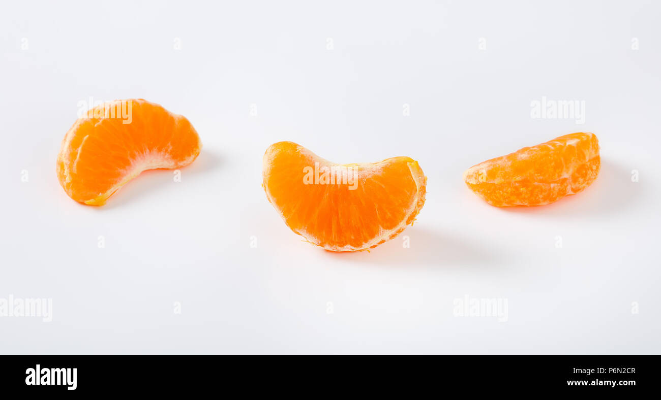 three slices of fresh tangerine on white background Stock Photo