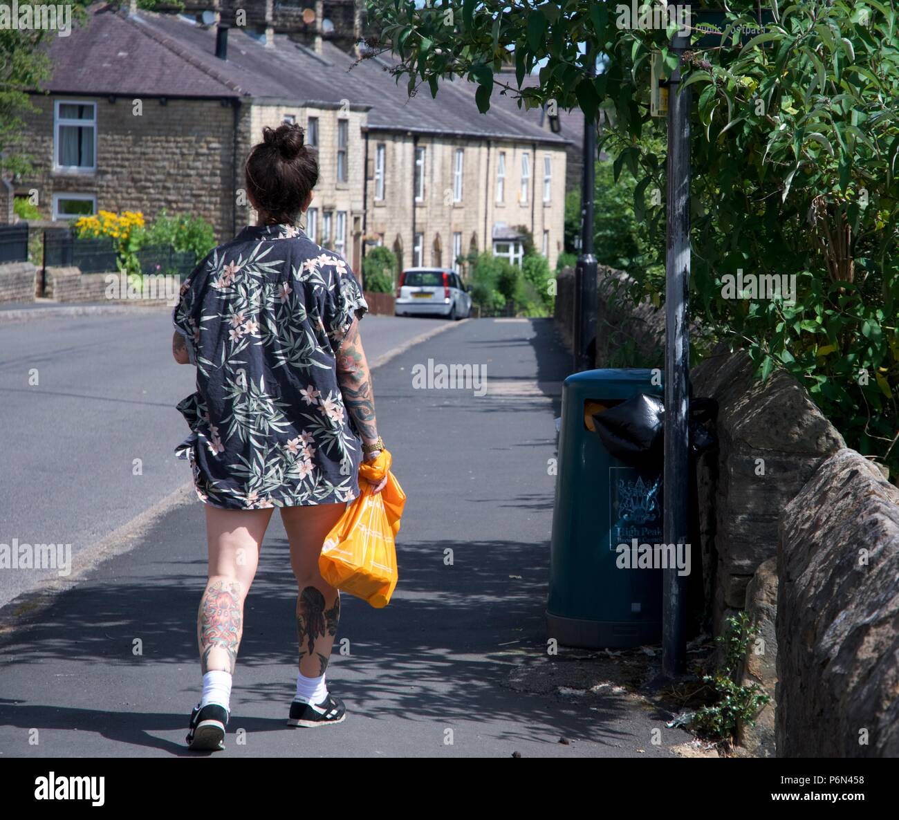 A heavily tattooed young woman in New Mills, Derbyshire. Stock Photo