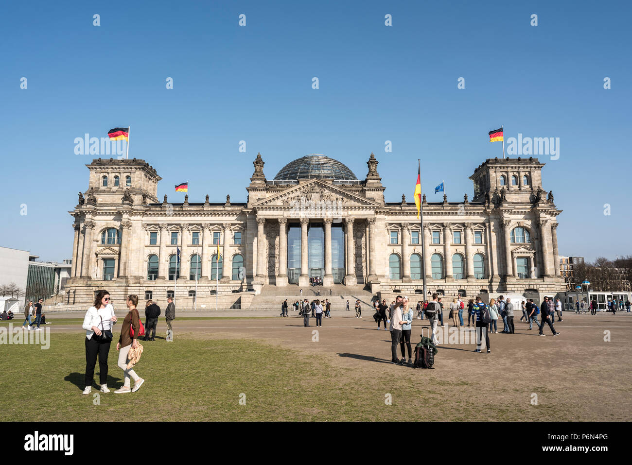 BERLIN, GERMANY, APRIL 8, 2018: The facade of Reichstag building in Berlin, many unidentified visitors and tourists. Stock Photo