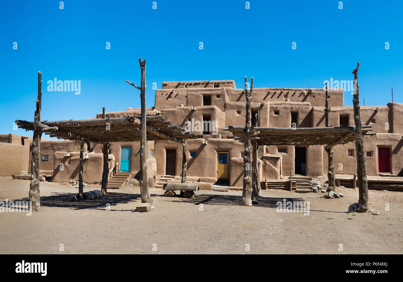 Adobe Buildings with Shade Structures. Taos Pueblo, New Mexico, continuously inhabited for over 1000 years. Stock Photo