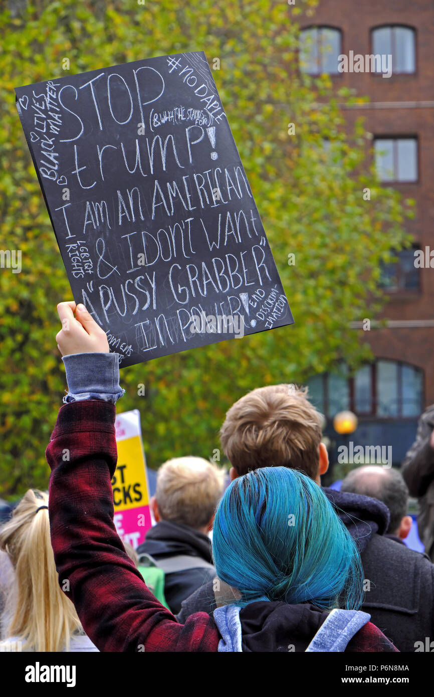 A woman holds a placard aloft at a demonstration against the election of Donald Trump as US president in Bristol, UK on 12 November 2016 Stock Photo