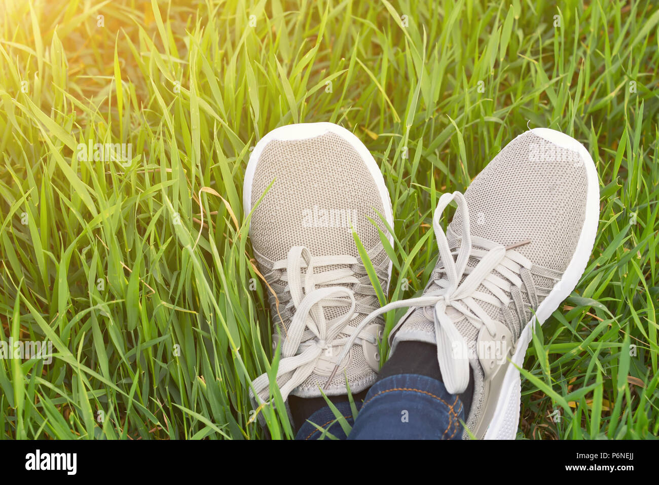 feet in boots on green, juicy grass in warm sunny weather Stock Photo ...