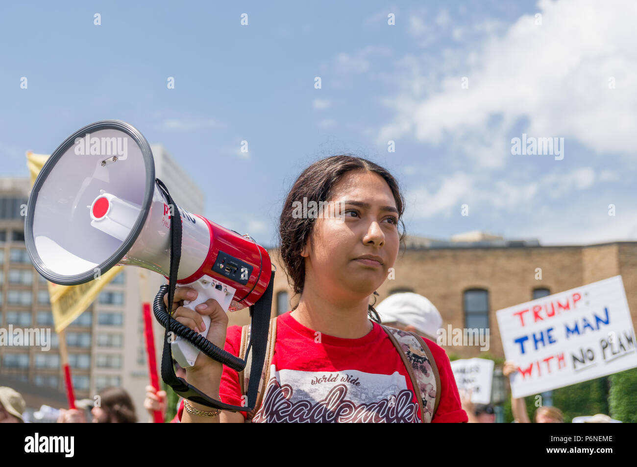 MINNEAPOLIS, MN/USA - JUNE 30, 2018: Unidentified individual holding a megaphone at  the Families Belong Together march. Stock Photo