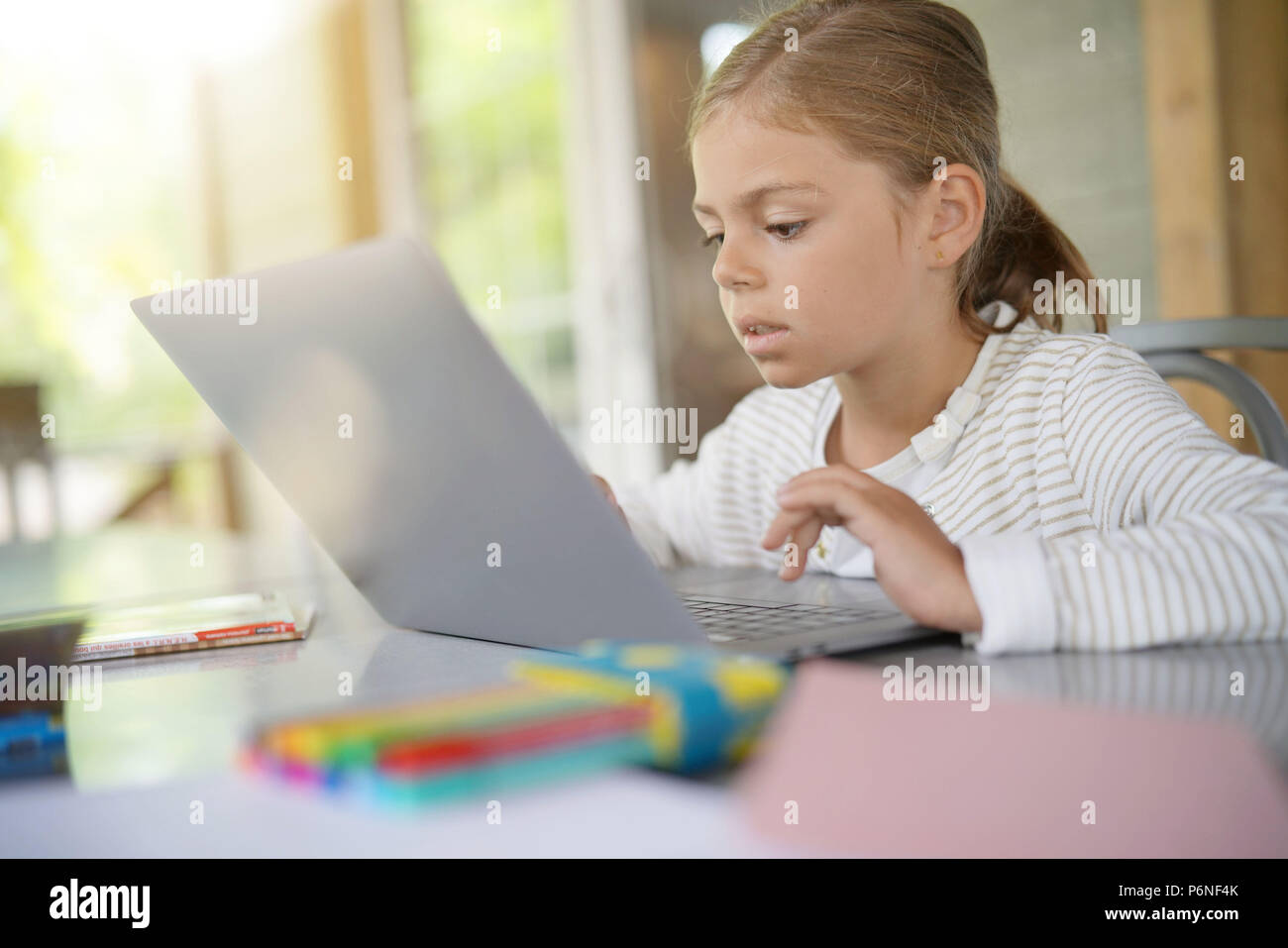 Schoolgirl working on laptop computer Stock Photo - Alamy