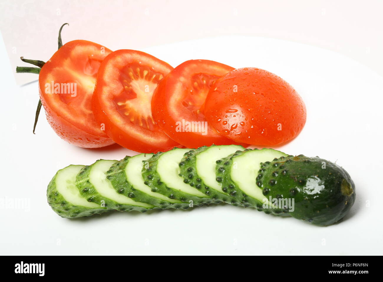 sliced tomato and cucumber on white background Stock Photo - Alamy