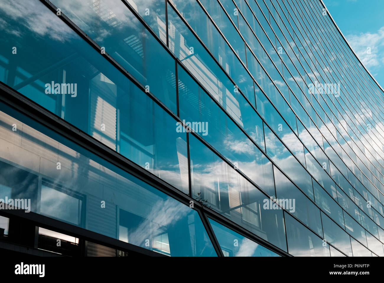 glass facade of modern office building and blue sky Stock Photo