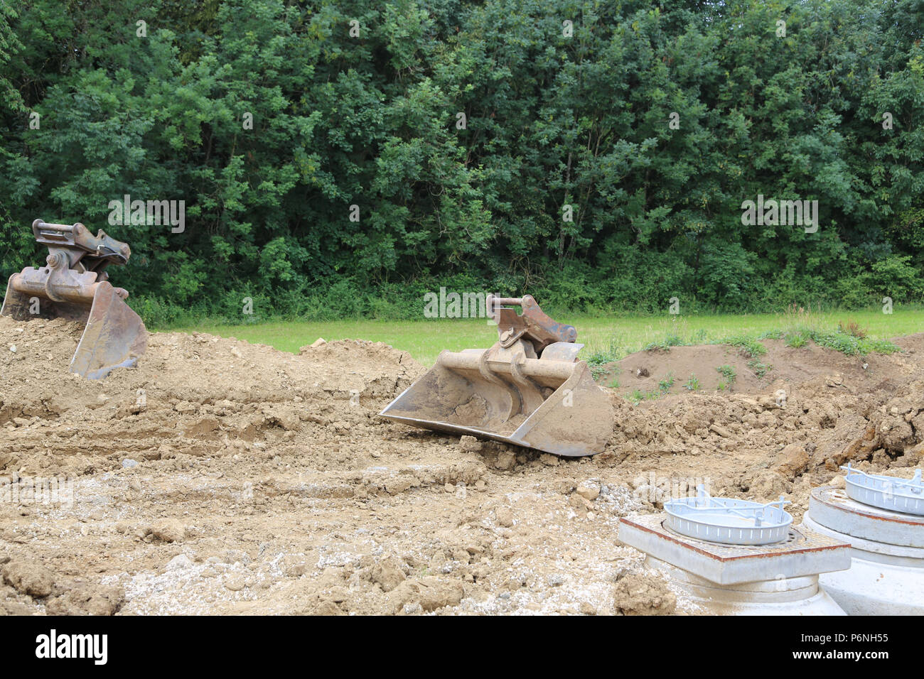 Utility line have been laid for the construction of a new residential community in Germany.The digger prepares the soil for the construction of houses Stock Photo