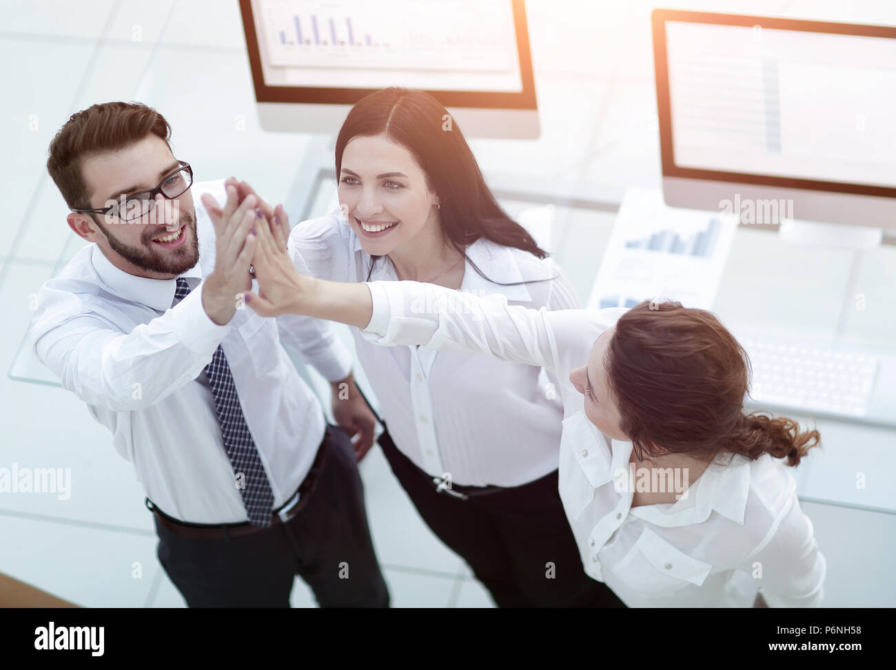 successful business team giving each other a high five Stock Photo - Alamy