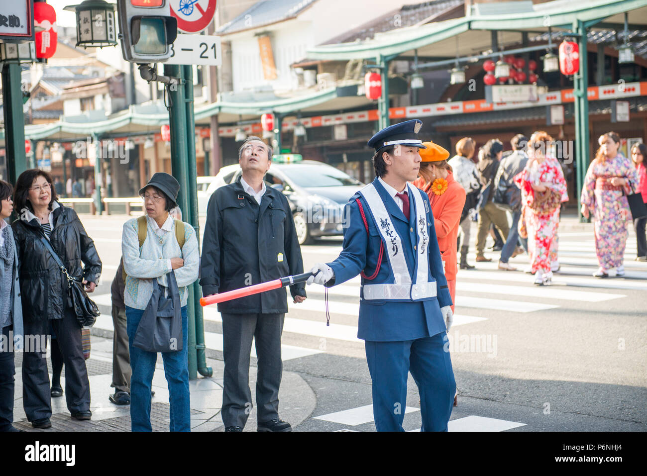Japanese traffic police in action on a busy street in the Gion district of Kyoto Stock Photo