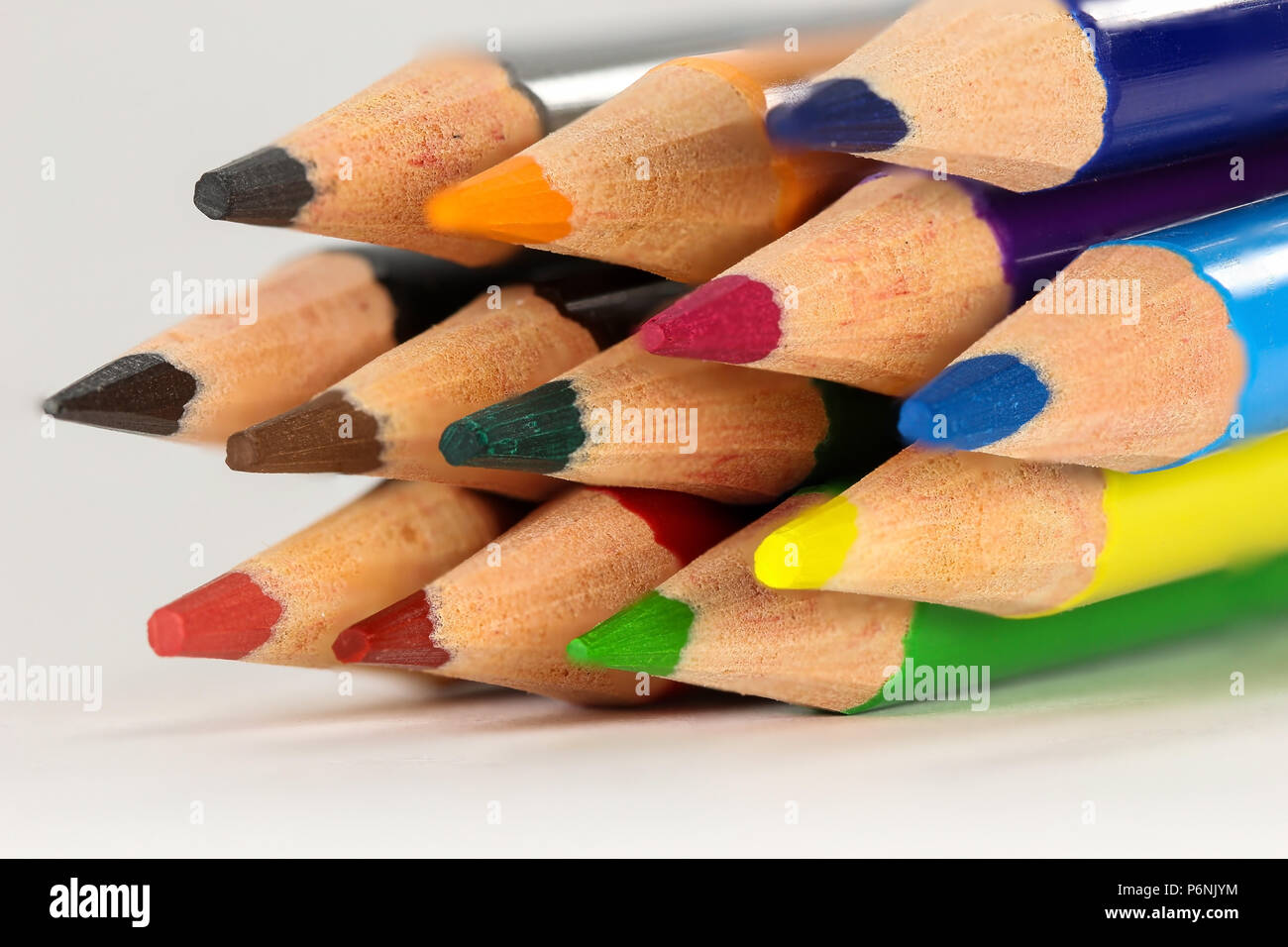 Colored pencils in macro closeup. Colored pencils are related to education, the arts and the painting of drawings. Stock Photo
