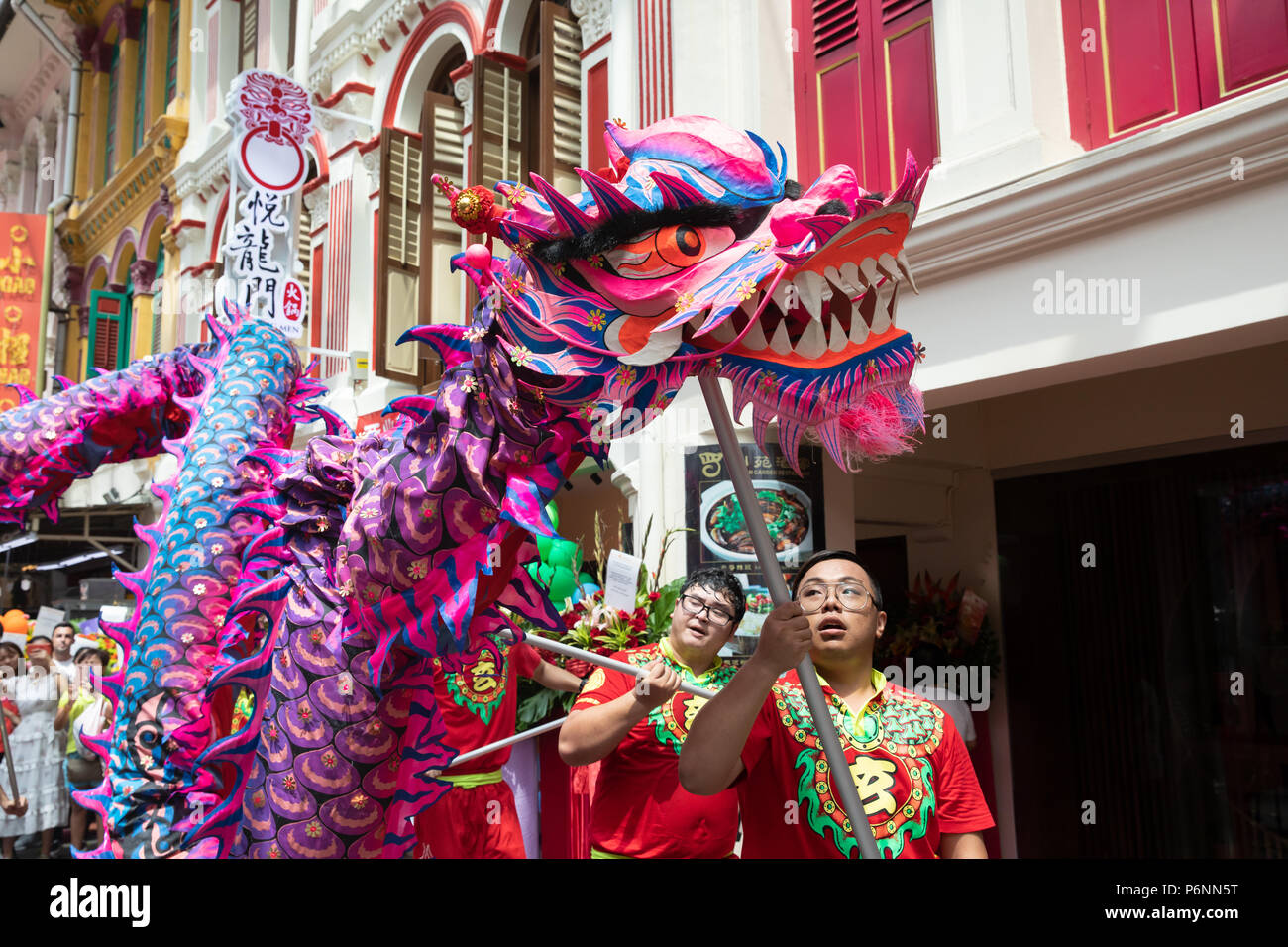 Singapore - Jun23, 2018: Colorful and symbolic Chinese dragon dance on the streets of Singapore Chinatown on the occasion of the opening of a new rest Stock Photo