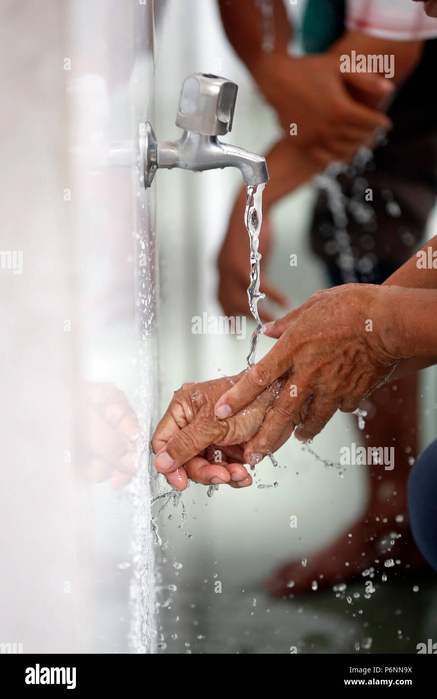 Masjid Al Rahim Mosque. Ritual purity in Islam. Muslim performing Wudu ...