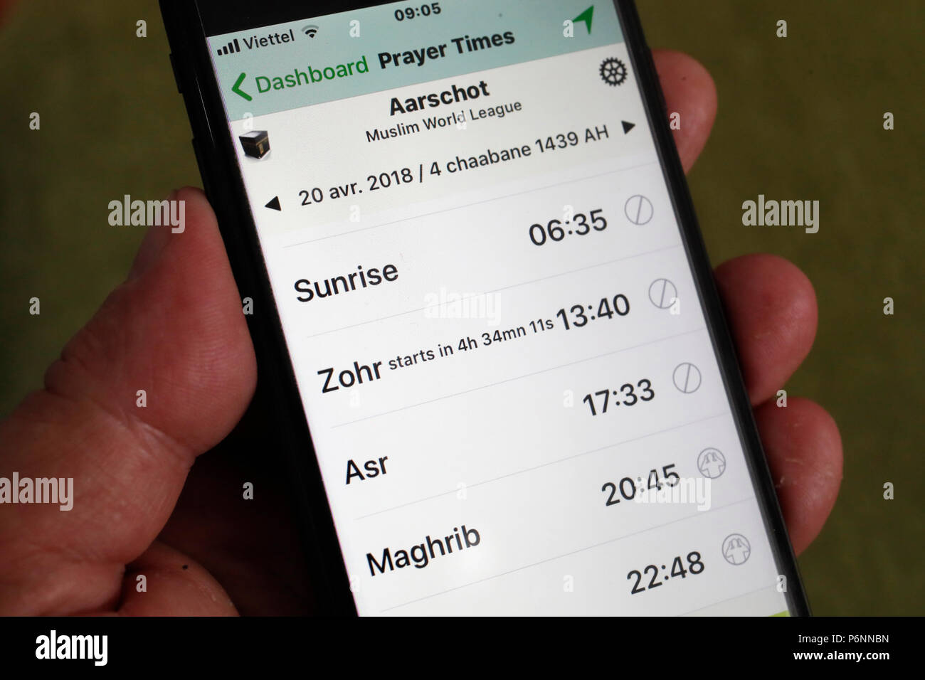 Muslim prayers time on a smartphone. Salaat timings alarm. Stock Photo