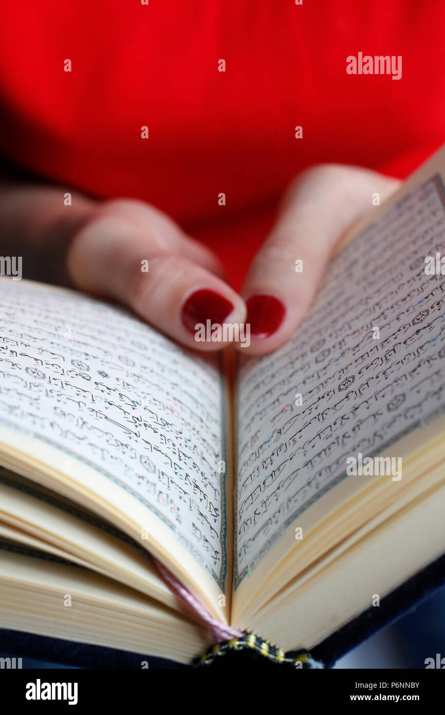 Woman reading the  Quran. Close-up. Stock Photo
