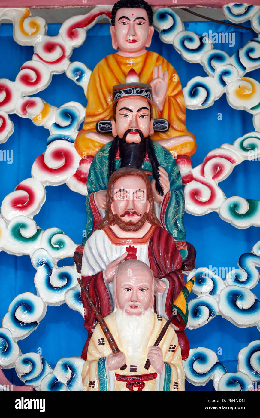 Cao Dai temple.   Lao Tseu, Jesus, Bouddha and Confucius.  Cai be. Vietnam. Stock Photo