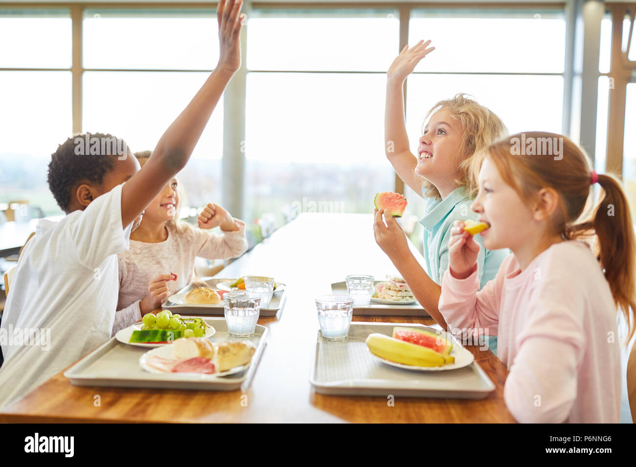 Group of children in the canteen having lunch or breakfast are having fun Stock Photo