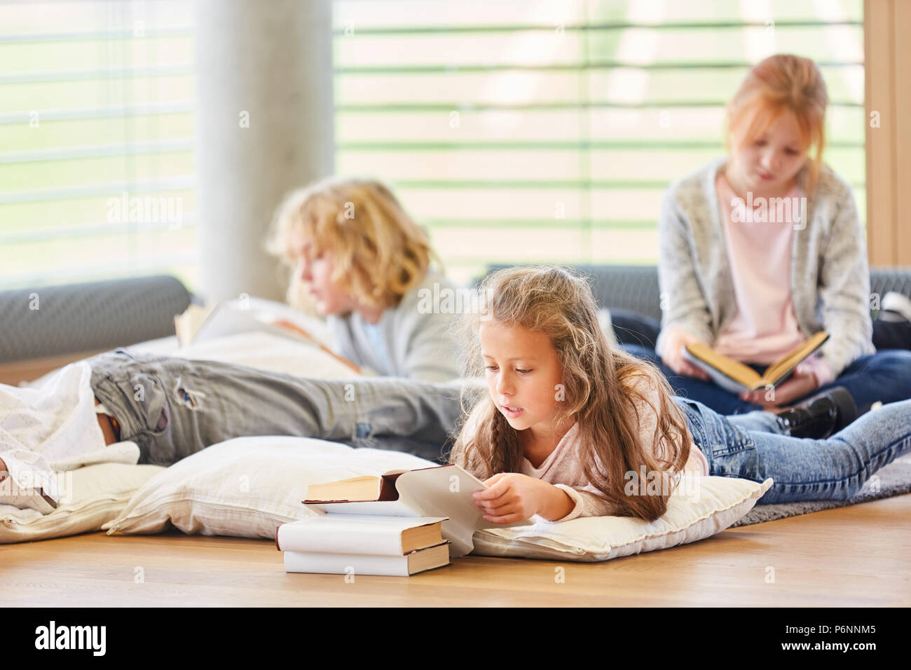 Group of kids together read children's books and storybooks Stock Photo