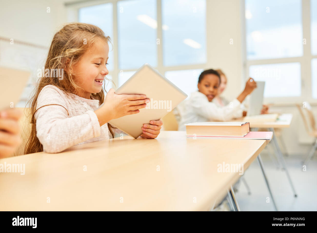 Girl as a student in elementary school lessons is having fun learning Stock Photo