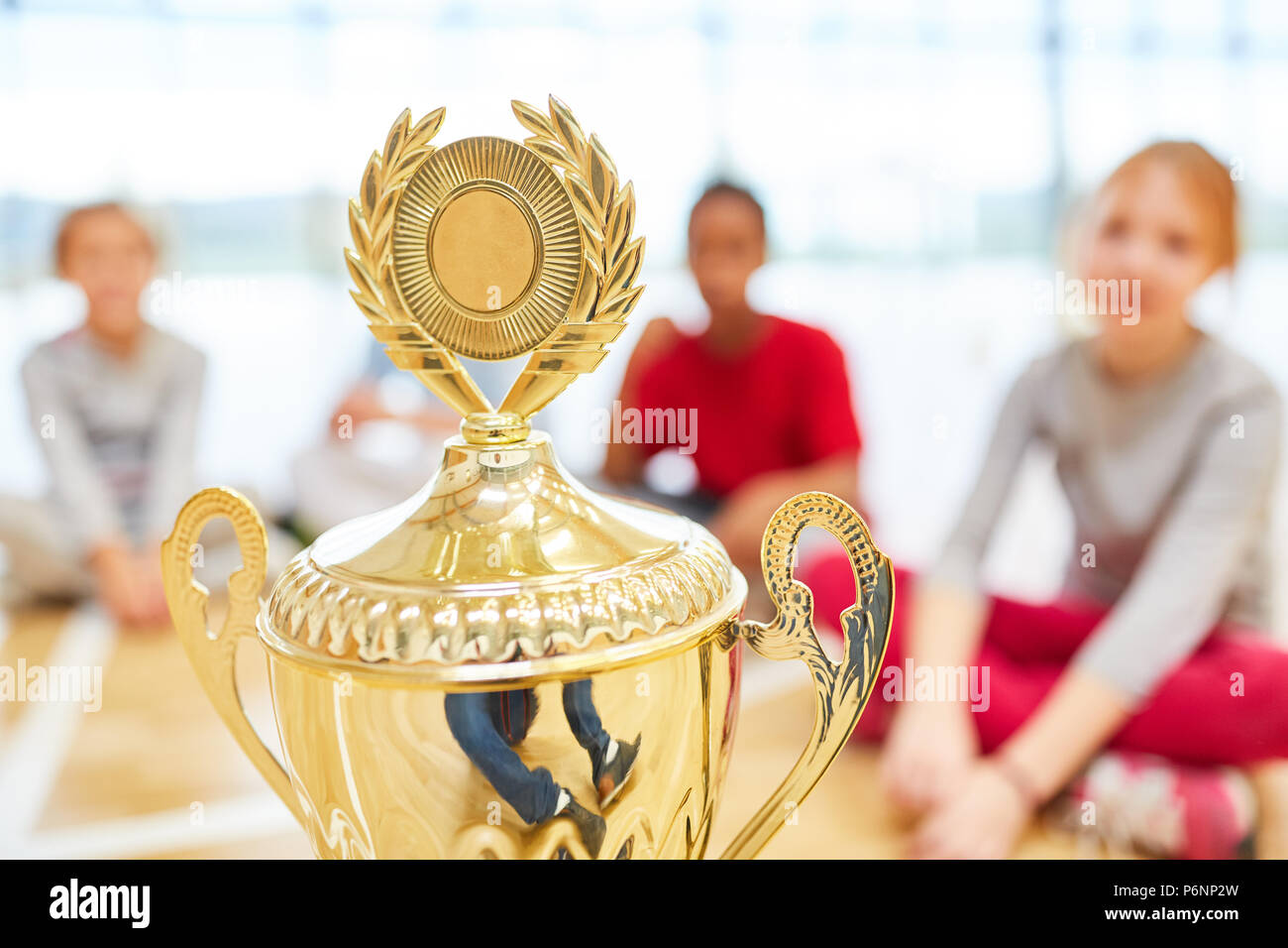 Winners cup at a competition in school sports with children in the background Stock Photo Alamy