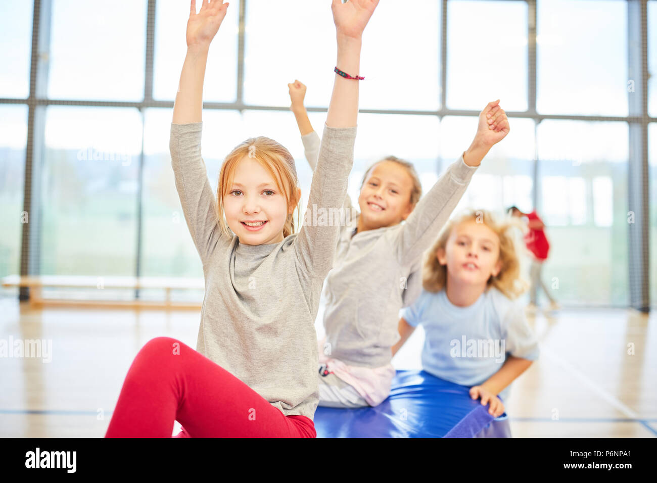 Group of kids of elementary school in the gym during a gym exercise Stock Photo
