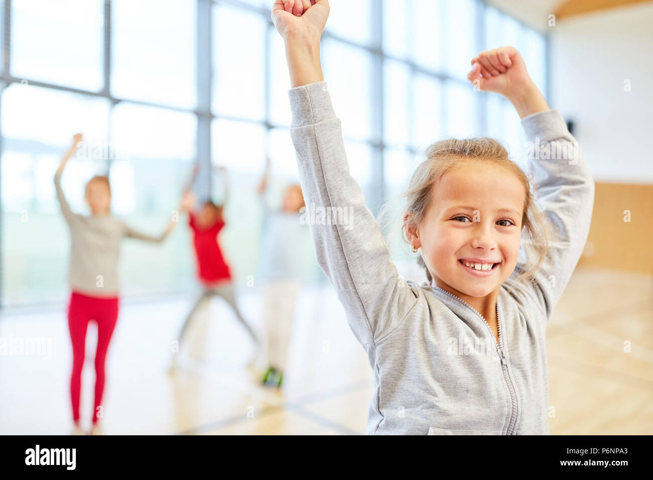 Girl is looking forward to physical education in the gymnasium of elementary school Stock Photo