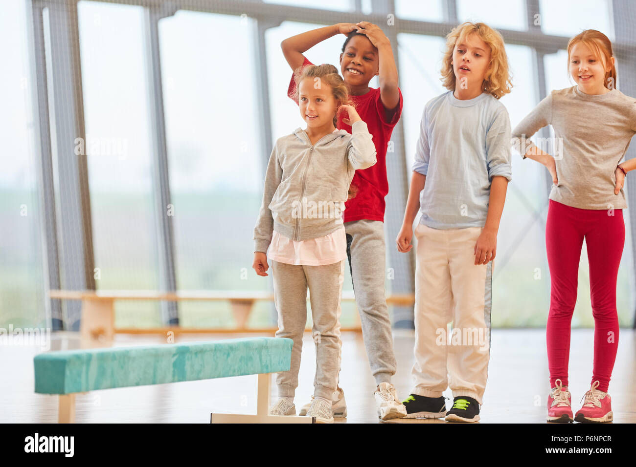 Group of kids in primary school physical education in a sports hall ...