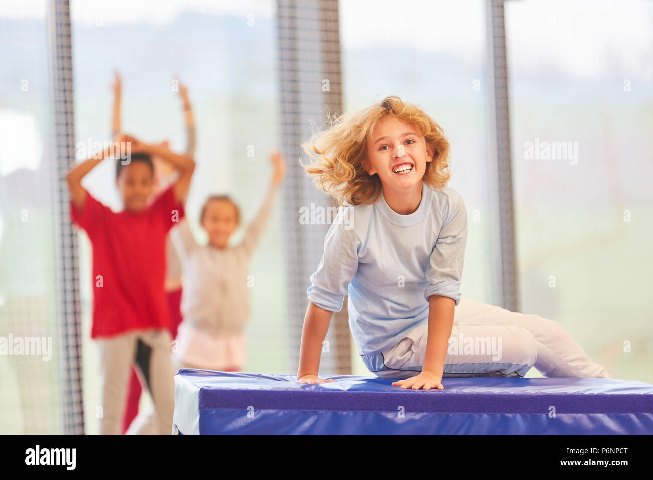 Students have fun in physical education at a competition in the gym Stock Photo