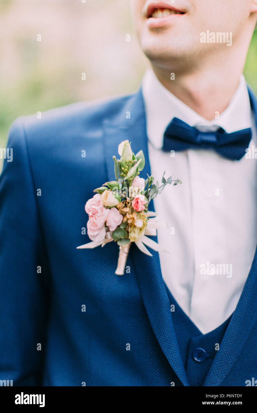 The boutonniere of roses on the jacket of the groom. Stock Photo