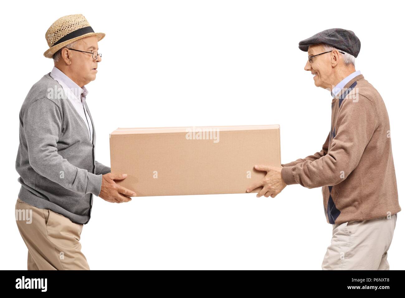 Seniors carrying a big cardboard box isolated on white background Stock Photo