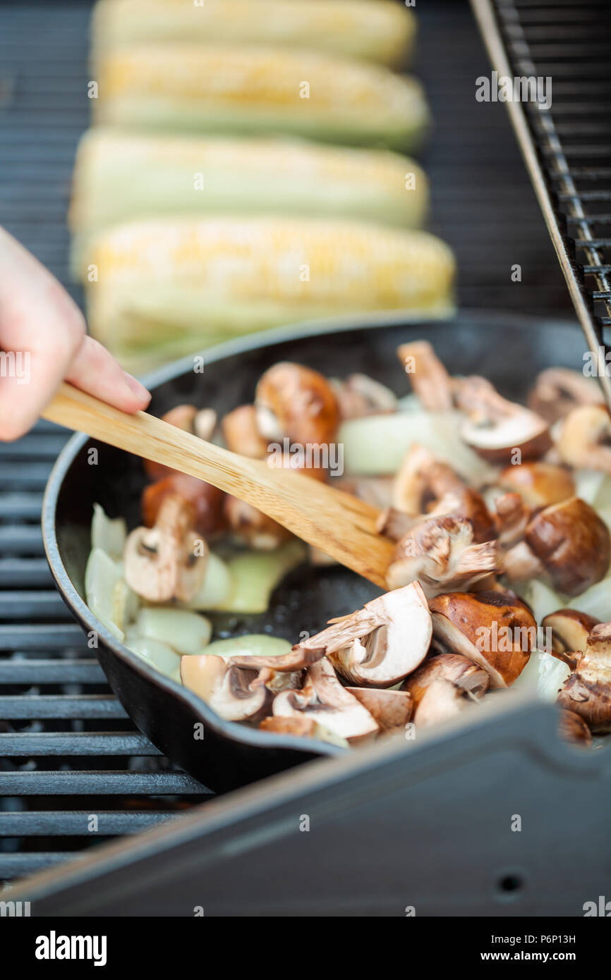 Step by step. Grilled mushrooms and onions in cast iron frying pan on